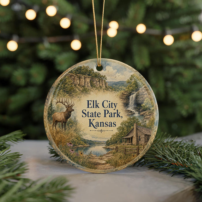 A round ornament with a scenic landscape featuring a deer, a waterfall, and a cabin, hanging on a string.