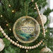 A round ornament on a Christmas tree, featuring a scenic image of Fanning Springs State Park in Florida.