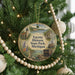 A round ornament hanging on a Christmas tree, featuring a scenic image of Fayette Historic State Park, Michigan.