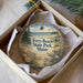 A decorative ornament in a box, featuring a beach scene with a bird and flowers, and the text "Ferry Beach State Park, Maine".