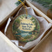 A round ornament with a scenic image of Fish Trap Lake State Park, Kentucky, hanging from a string.