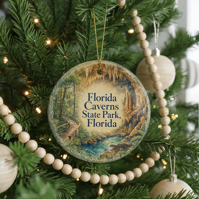 A round ornament hanging on a Christmas tree, featuring a scenic image of the Florida Caves State Park.