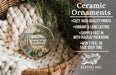 Ceramic ornaments, featuring a round ornament with a design of a park and a bird, hanging in a basket with pine branches.