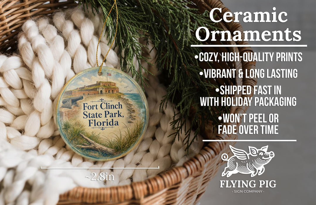 Ceramic ornaments, featuring a round ornament with a design of Fort Clinch State Park, Florida, hanging from a wicker basket.