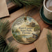 A round ornament with a painting of Fort Cooper State Park in Florida, featuring a lighthouse, palm trees, and a boat on the water.