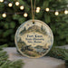 A round ornament with a picture of Fort Knox, Maine, featuring a cannon, a sailboat, and a building, surrounded by Christmas lights.