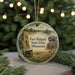 A round ornament featuring a scenic landscape with a castle, a cannon, and a field, with the text "Fort Ridgely State Park, Minnesota" displayed on it.