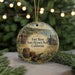 A round ornament with a picture of Fort Ross State Historic Park, California, featuring a cannon, barrels, and a building.