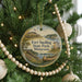 A round ornament hanging on a Christmas tree, featuring a scenic image of Fort Snelling State Park, Minnesota.