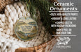 Ceramic ornaments, featuring a painting of Fort Snelling State Park, Minnesota, hanging in a basket with pine branches.