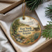 A round ornament with a scenic image of Fort Verde State Historic Park, Arizona, hanging from a string.
