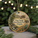 A round ornament with a painting of Fort Verde State Historic Park, Arizona, hanging from a string.