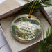 A decorative ornament in a box, featuring a scenic landscape with a house and trees, with the text "Fort Yargo State Park, Georgia" prominently displayed.