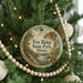 A round ornament hanging on a Christmas tree, featuring a scenic image of Fox Ridge State Park in Illinois.