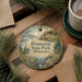 A decorative ornament featuring a scenic landscape of Frontenac State Park in Minnesota, with pine trees and a lake in the background.