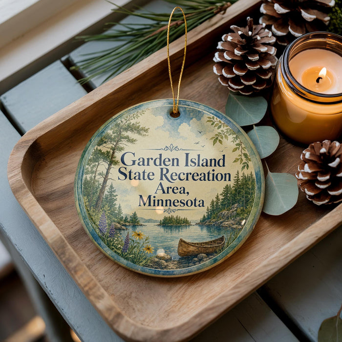 A wooden tray with a decorative ornament featuring a scenic landscape of a lake, pine trees, and a boat, along with pine cones and a lit candle.