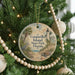 A round ornament hanging on a Christmas tree, featuring a lighthouse and palm trees, with the text "Gasparilla Island State Park, Florida" displayed on it.