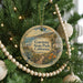 A round ornament hanging on a Christmas tree, featuring a scenic image of Gaviota State Park, California.