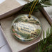 A decorative ornament in a box, featuring a scenic image of General Butler State Resort Park in Kentucky.