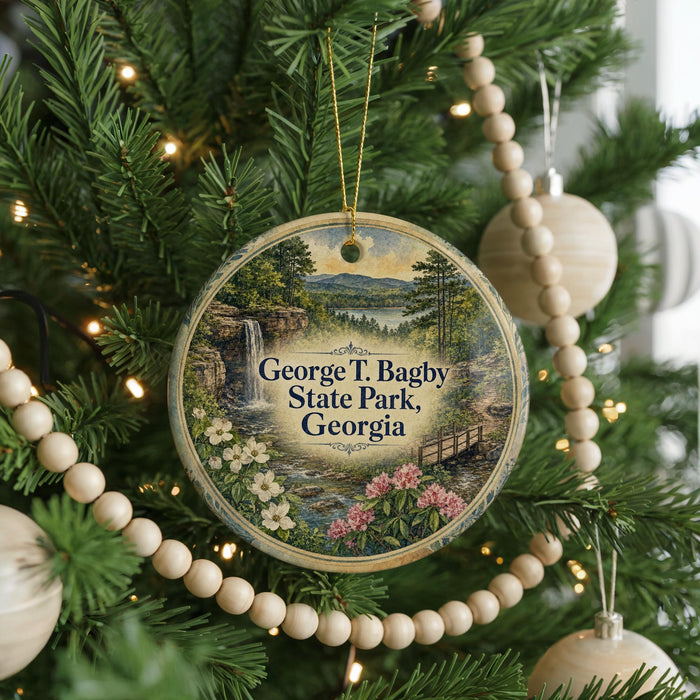 A round ornament hanging on a Christmas tree, featuring a scenic landscape with a waterfall and flowers.