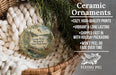 Ceramic ornaments, featuring a scenic image of Georgia Wyeth Memorial State Park, Iowa. The ornaments are described as cozy, high-quality prints, vibrant, and long lasting, and are shipped fast in holiday packaging. They are not to be peeled or faded over time. The image is a close-up of the ornaments, with a wicker basket and greenery in the background.