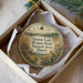 A decorative ornament in a box, featuring a landscape with a bird and flowers, along with text that reads "Goose Lake Prairie State Natural Area, Illinois".