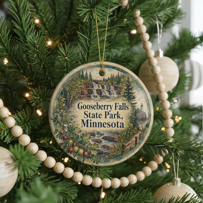 A circular ornament hanging on a Christmas tree, featuring a scenic image of Gooseberry Falls State Park in Minnesota.