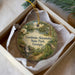 A circular ornament with a scenic landscape of a river, waterfall, and greenery, along with the text "Gordonia-Alatamaha State Park, Georgia".