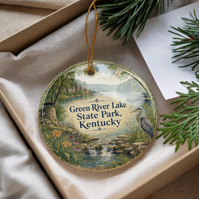 A decorative ornament with a scenic landscape of Green River Lake State Park, Kentucky, featuring a heron and a waterfall.