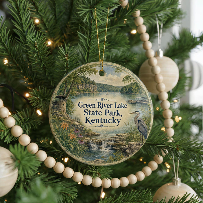 A round ornament hanging on a Christmas tree, featuring a scenic image of Green River Lake State Park, Kentucky.
