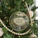 A round ornament hanging on a Christmas tree, featuring a scenic image of Green River Lake State Park, Kentucky.