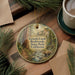 A decorative ornament featuring a scenic image of Grizzly Creek in Redwoods State Park, California.