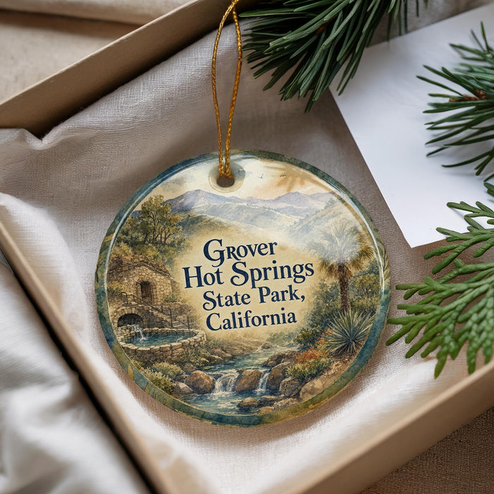 A decorative ornament with a scenic landscape of Grover Hot Springs State Park, California, featuring a waterfall and mountains.
