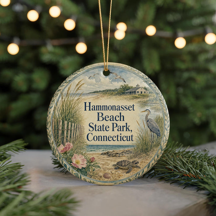 A round ornament with a beach scene and a bird, hanging on a string.