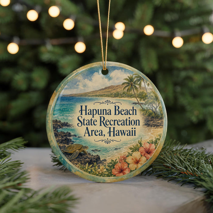 A circular ornament with a beach scene and palm trees, featuring the text "Hapuna Beach State Recreation Area, Hawaii" on it.