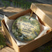 A decorative ornament in a wooden box, featuring a scenic image of Hard Labor Creek State Park in Georgia.