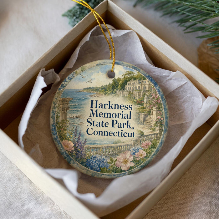 A decorative ornament in a white box, featuring a scenic image of Harkness Memorial State Park in Connecticut.