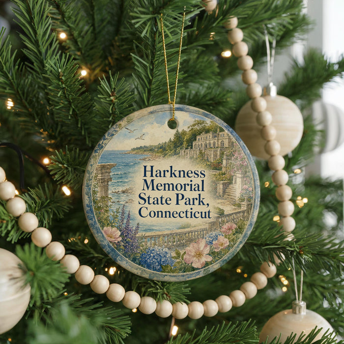 A round ornament hanging on a Christmas tree, featuring a scenic image of Harkness Memorial State Park, Connecticut.