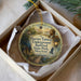 A decorative ornament in a box, featuring an illustration of Harriet Tubman and the Underground Railroad Railroad State Park, Maryland.