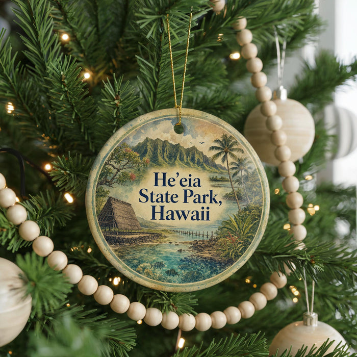 A round ornament hanging on a Christmas tree, featuring a scenic image of Hawaii.