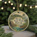 A circular ornament with a scenic image of a tropical landscape, including a beach, mountains, and palm trees, along with the text "He'eia State Park, Hawaii".