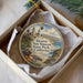 A decorative ornament in a box, featuring a scenic image of San Simeon State Park in California.