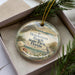 A decorative ornament in a box, featuring a beach scene with a bird and palm trees, along with the text "Henderson Beach State Park, Florida".