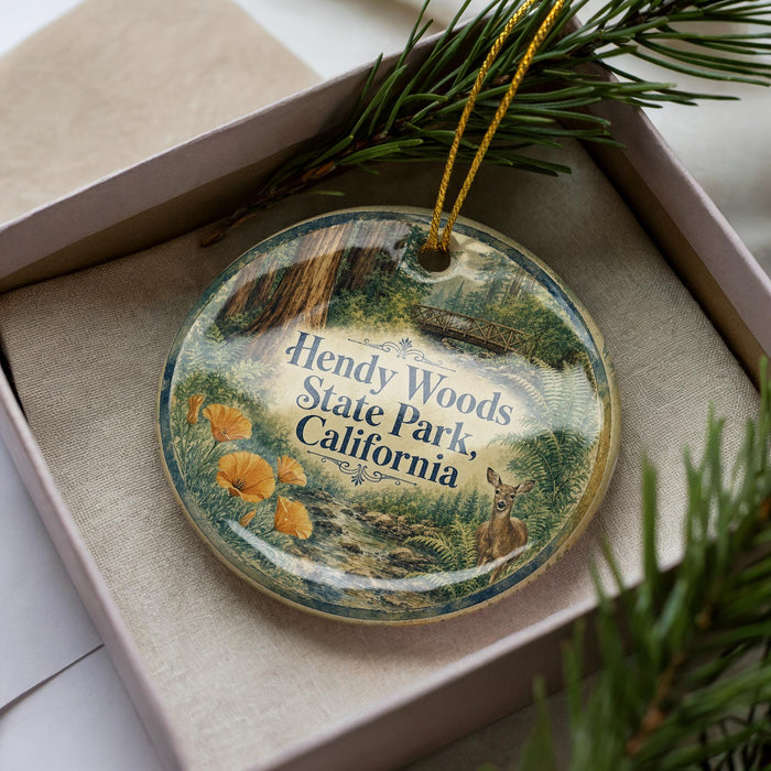 A decorative ornament in a box, featuring a scenic image of Hendy Woods State Park, California.