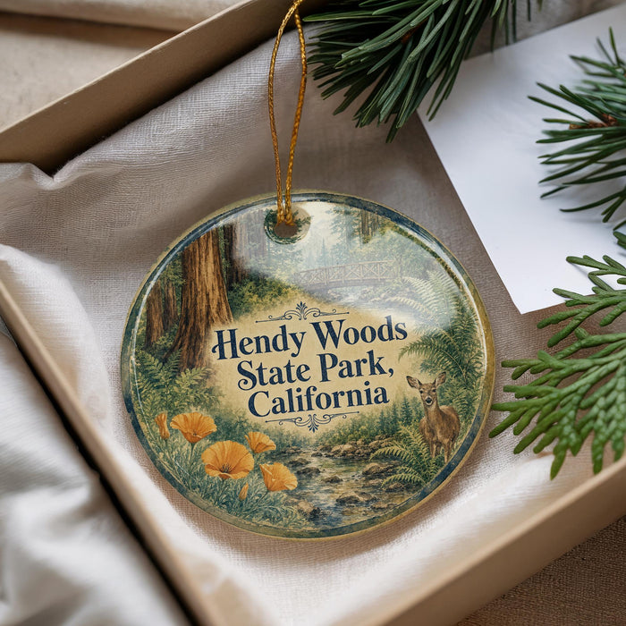 A round ornament with a forest scene and a deer, hanging from a string.