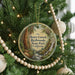 A round ornament hanging on a Christmas tree, featuring a scenic image of Henry Cowell Redwoods State Park, California.