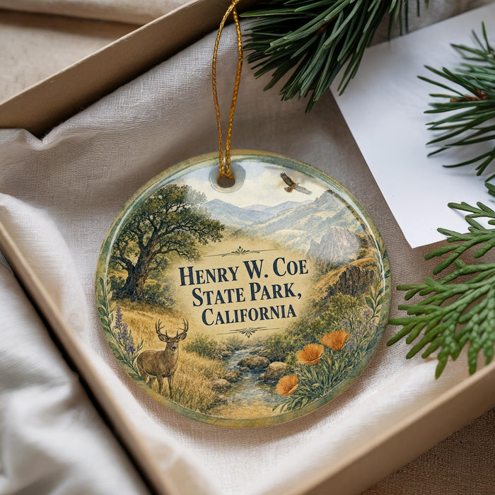 A decorative ornament with a landscape scene featuring a deer, pine trees, and mountains, along with the text "Henry W. Coe State Park, California".