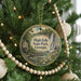 A round ornament hanging on a Christmas tree, featuring a scenic image of High Falls State Park in Georgia.