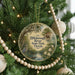 A round ornament hanging on a Christmas tree, featuring a scenic image of Hillsborough River State Park, Florida.