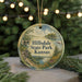 A decorative ornament with a scenic landscape of hills, trees, and a river, featuring the text "Hillsdale State Park, Kansas" prominently displayed.